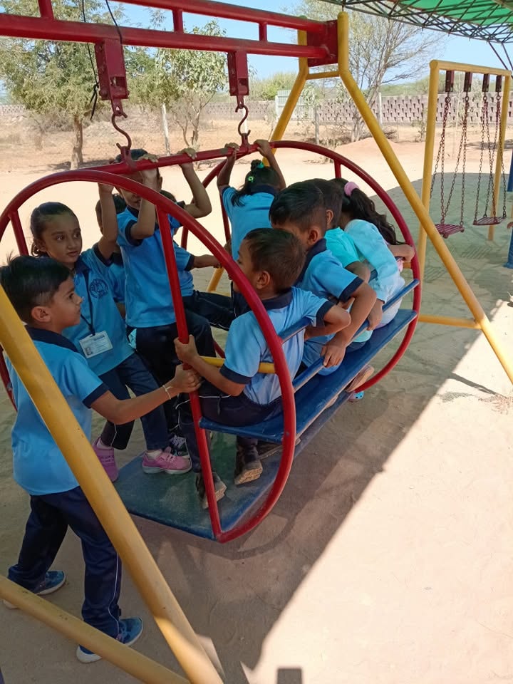 Kindergartners swinging together (1)