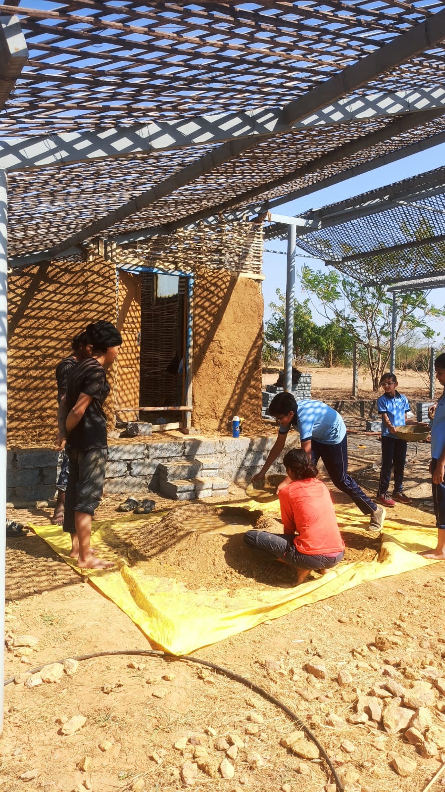 Learning to make buildings from mud and wattle